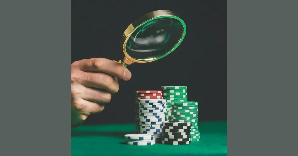 A person examines a stack of chips with a magnifying glass, contemplating strategies for betting without incurring losses